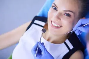 happy woman dental cleaning appointment