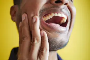 Photo by Towfiqu barbhuiya: https://www.pexels.com/photo/close-up-of-a-man-laughing-14624608/ - man experiencing jaw pain