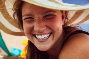 Photo by Skinny Tie Media : https://www.pexels.com/photo/close-up-shot-of-a-woman-with-big-smile-13147635/ - girl smiling with healthy gums and teeth